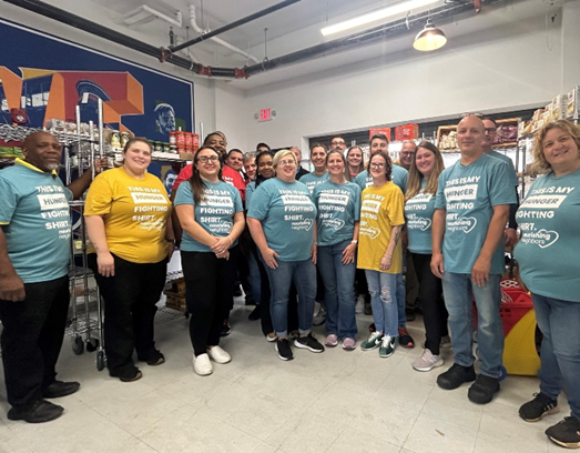 Group posing for a picture in food pantry