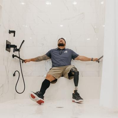 Wounded Veteran in his wheelchair accessible shower.