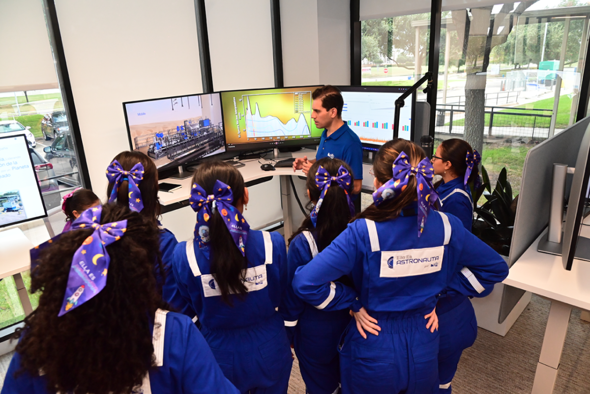 A group of students listening to someone speaking