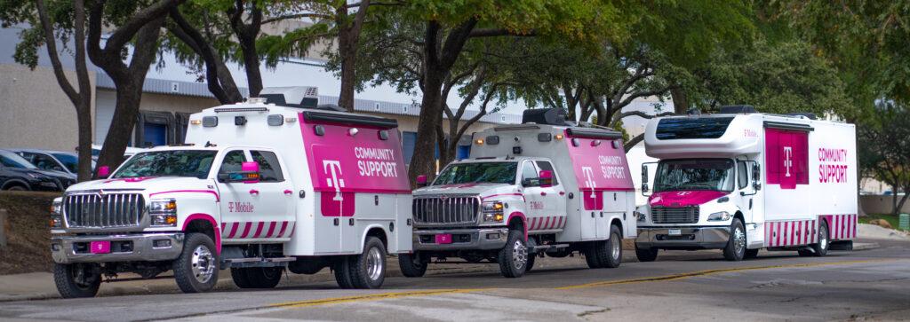 Three T-Mobile community support vehicles