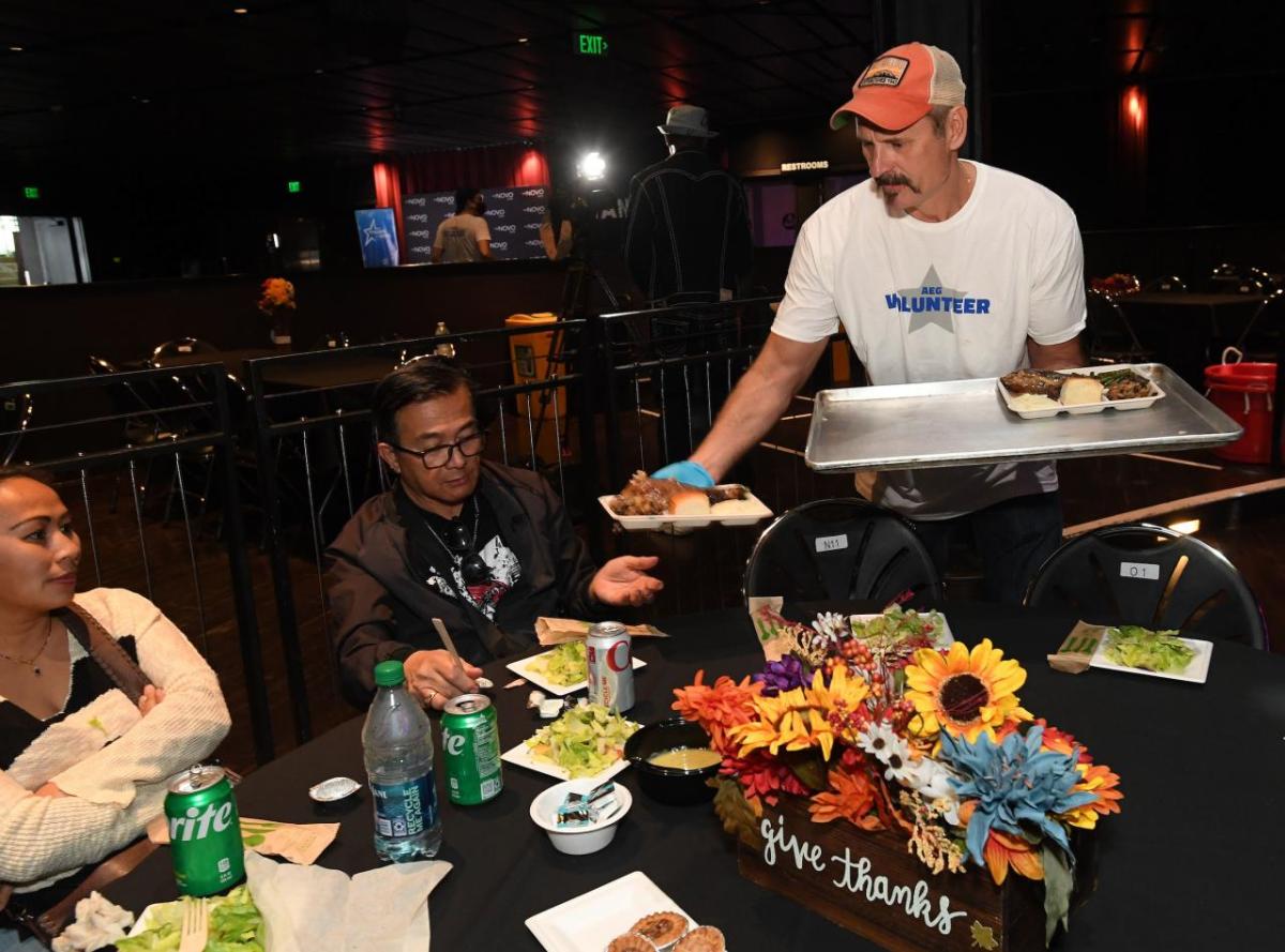 An AEG volunteer serves meals to veterans and their families at AEG's 11th Annual Community Thanksgiving at The Novo in Los Angeles, CA.