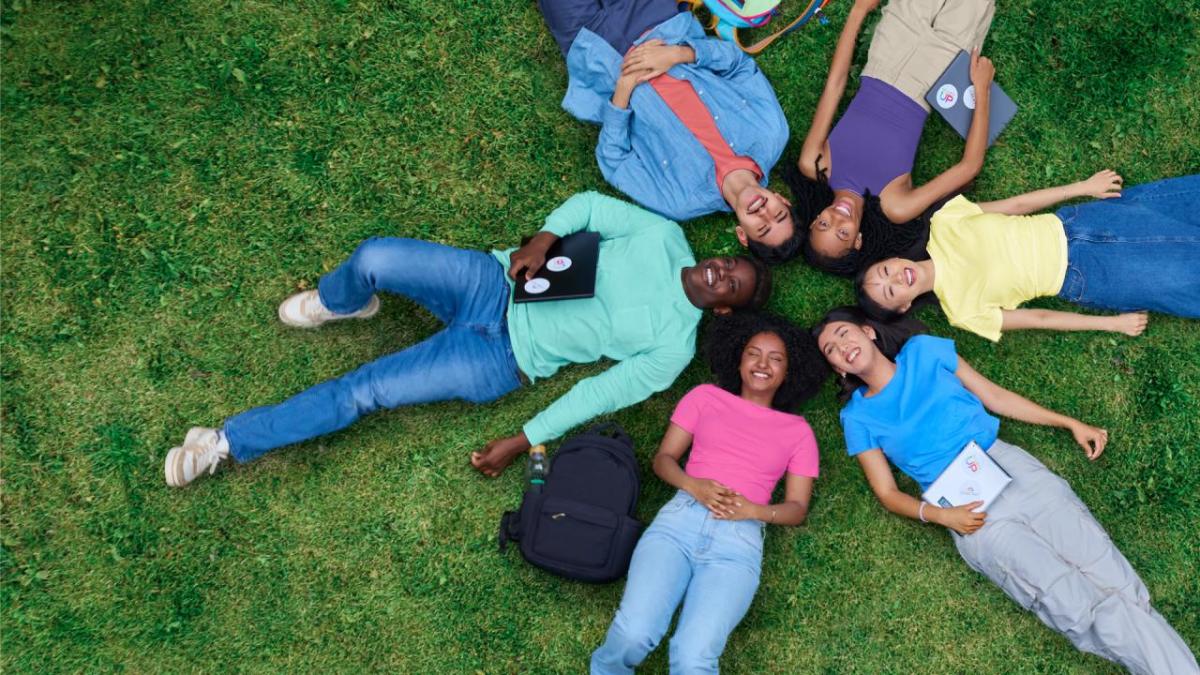 group of people laying on the ground in a circle