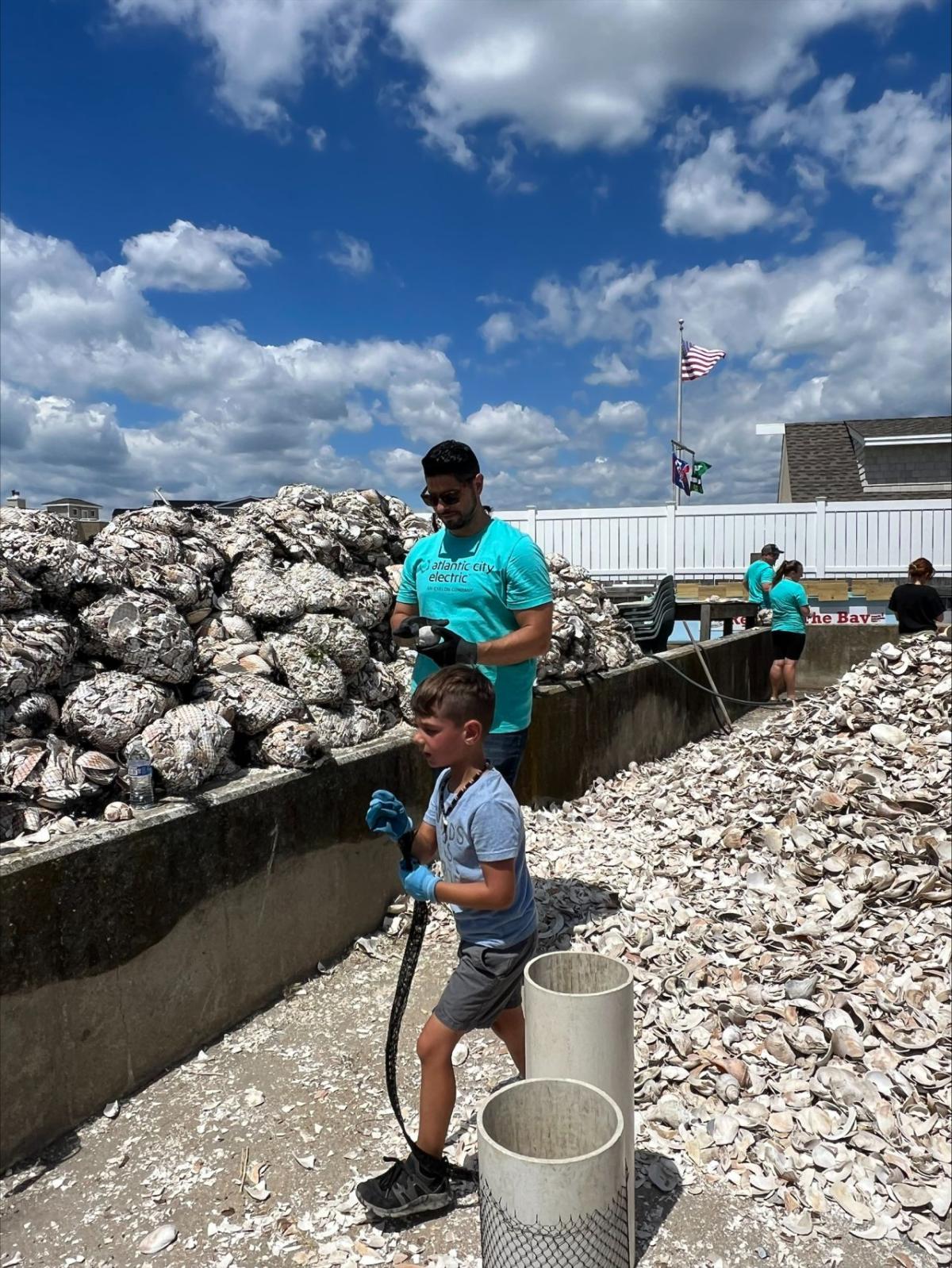 A child and adult helping to clean up the coast