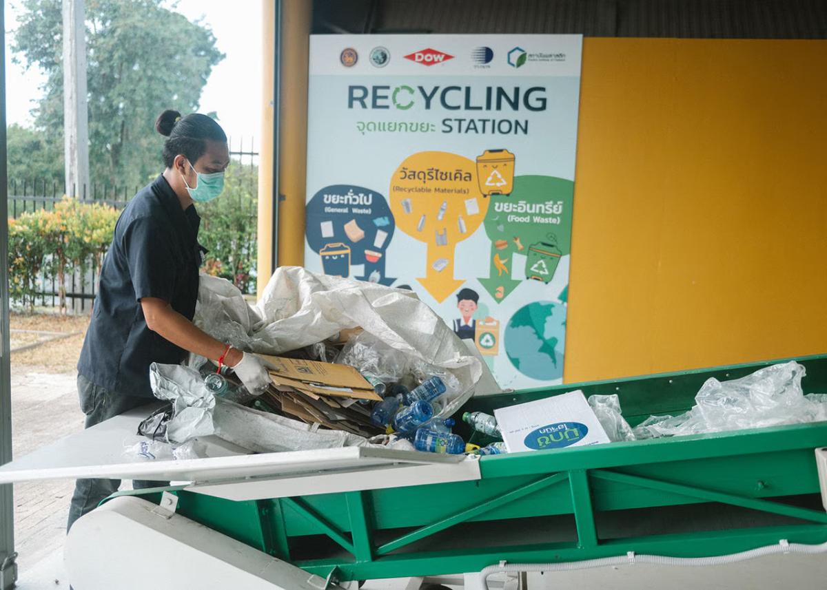 A person sorting through recycling 