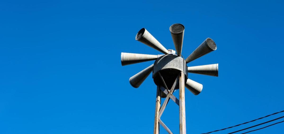 Civil defense sirens under a blue sky