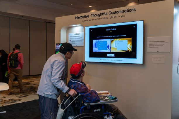 2 people visit the LG Exhibit at CSUN Assistive Technology Conference