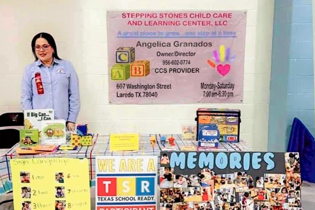 Angelica behind a table decorated and a poster behind her "Stepping Stones Child Care."