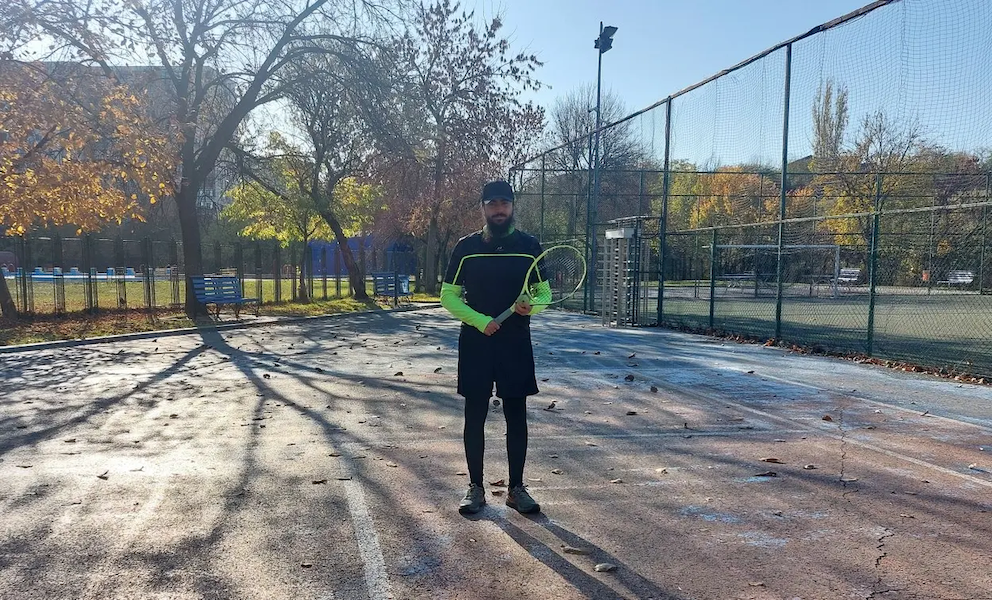 Armand on a tennis court.