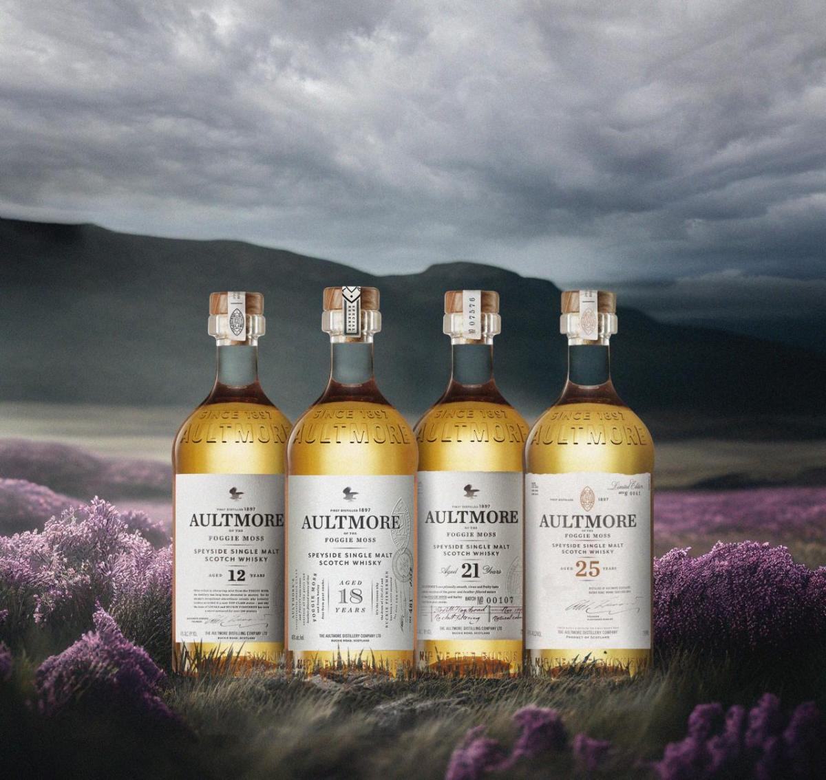 Four bottles of Aultmore on a digitized storm sky and landscape.