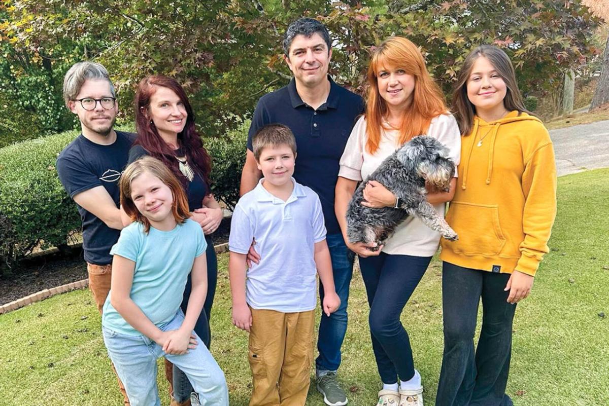 The Sviatyi family and host family posed outside