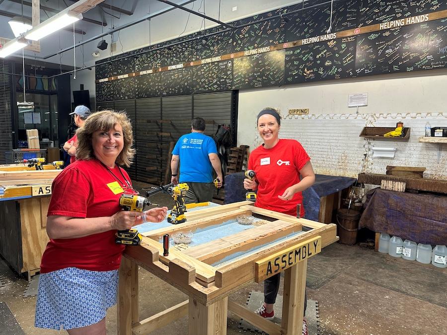 KeyBank volunteers preparing to assemble a bedframe.