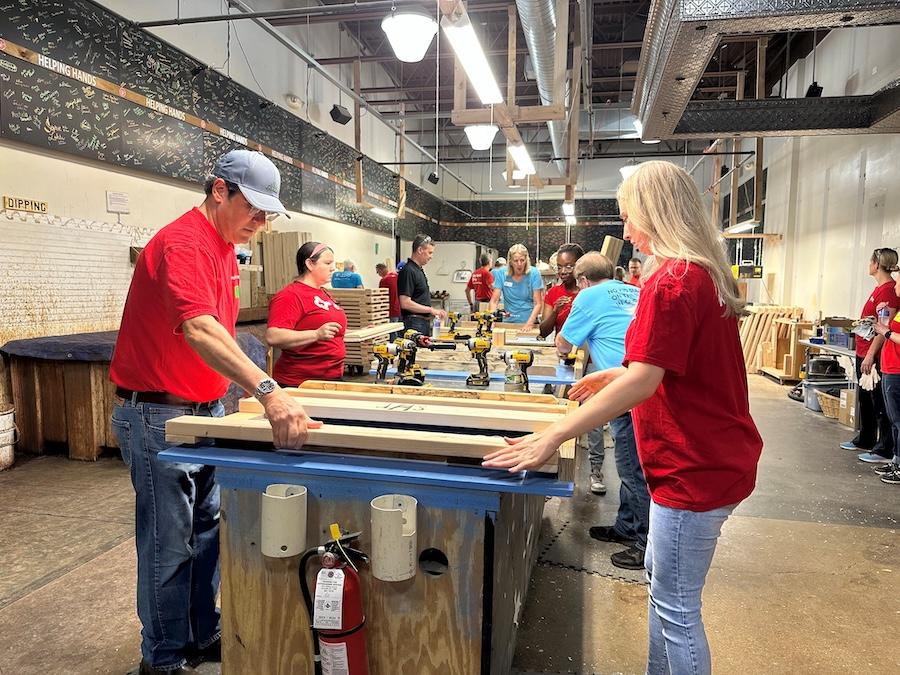 KeyBank volunteers laying out the bedframes.