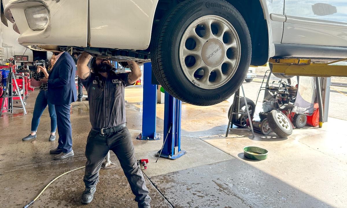 person working on a car up on a lift