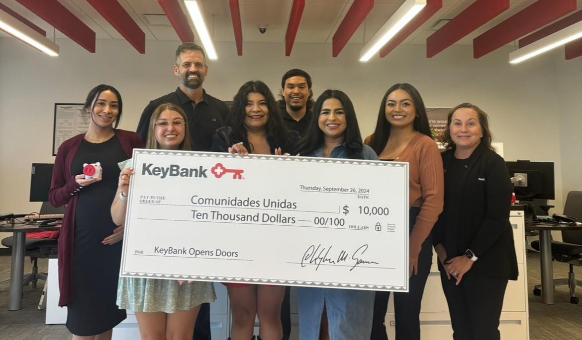 Team members from KeyBank and Salt Lake City's Comunidades Unidas shown with a $10,000 grant check.