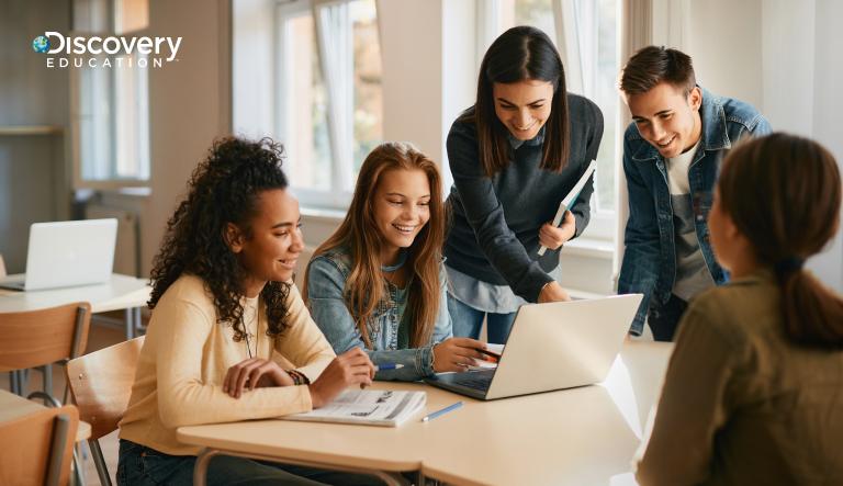 students looking at a laptop together