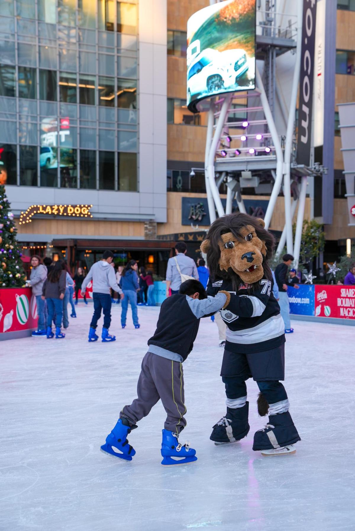 LA Kings mascot Bailey taught a young child how to ice skate during AEG's Community Holiday Party in Los Angeles, CA.