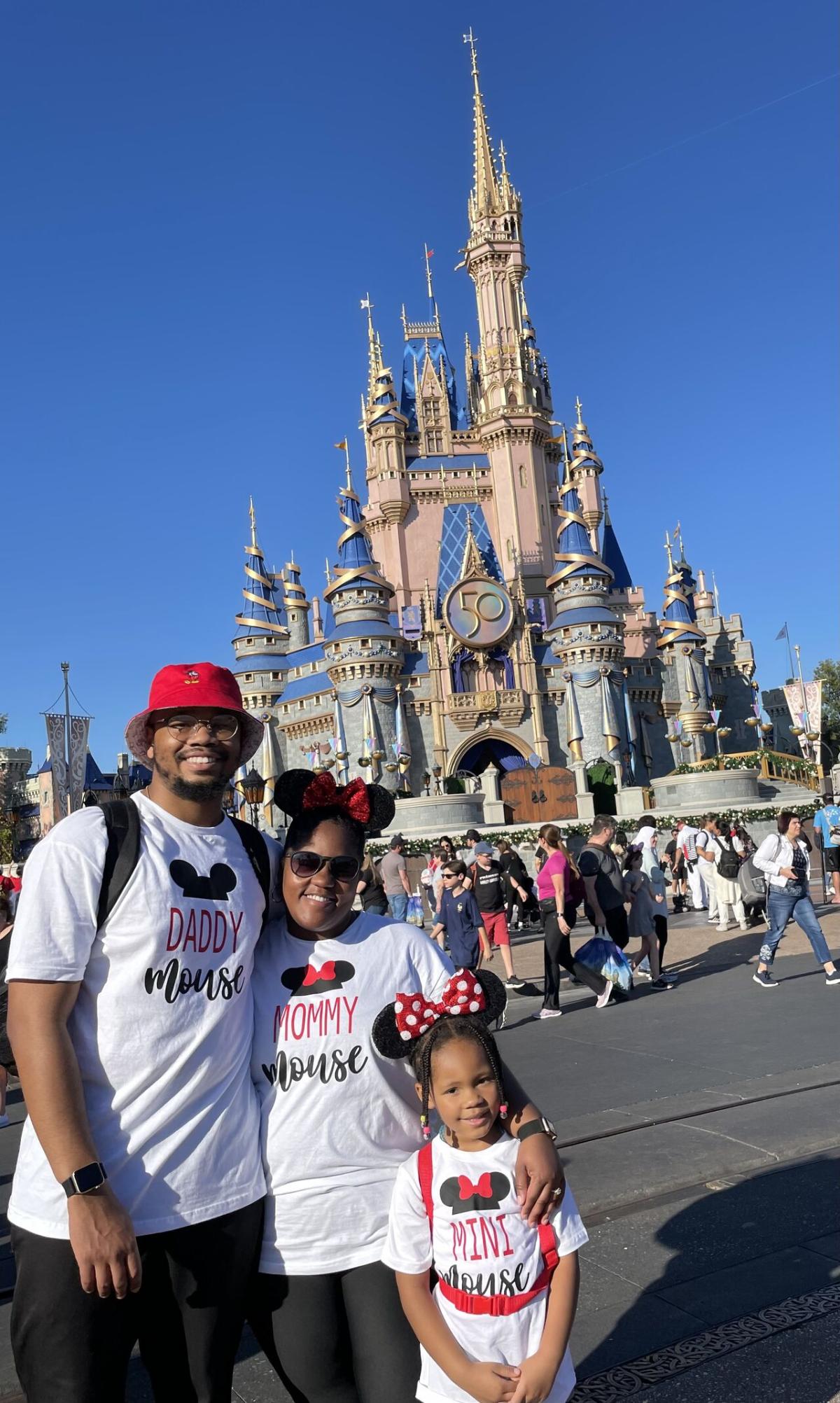 Dexter Thompson and family, a Disney castle in the background.