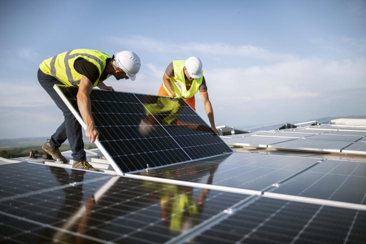 Workers installing solar panels.