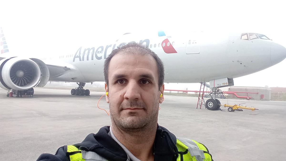 A person taking a selfie in front of an aeroplane