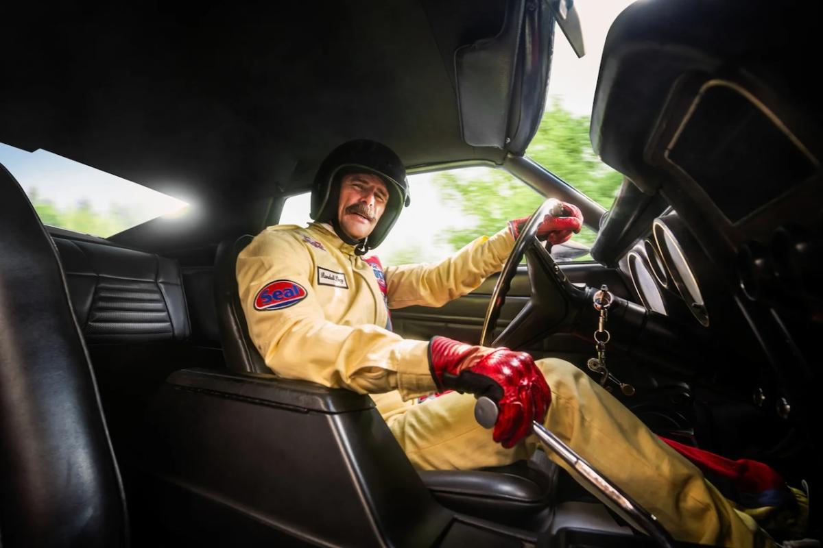 Walter behind the wheel of a race car.