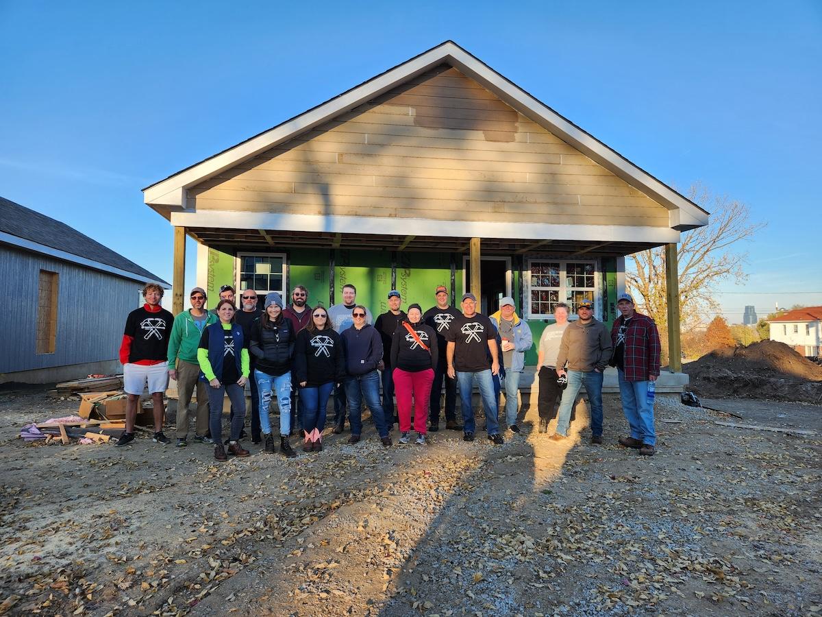 Wesco employees shown in front of a Veterans Habitat for Humanity home.
