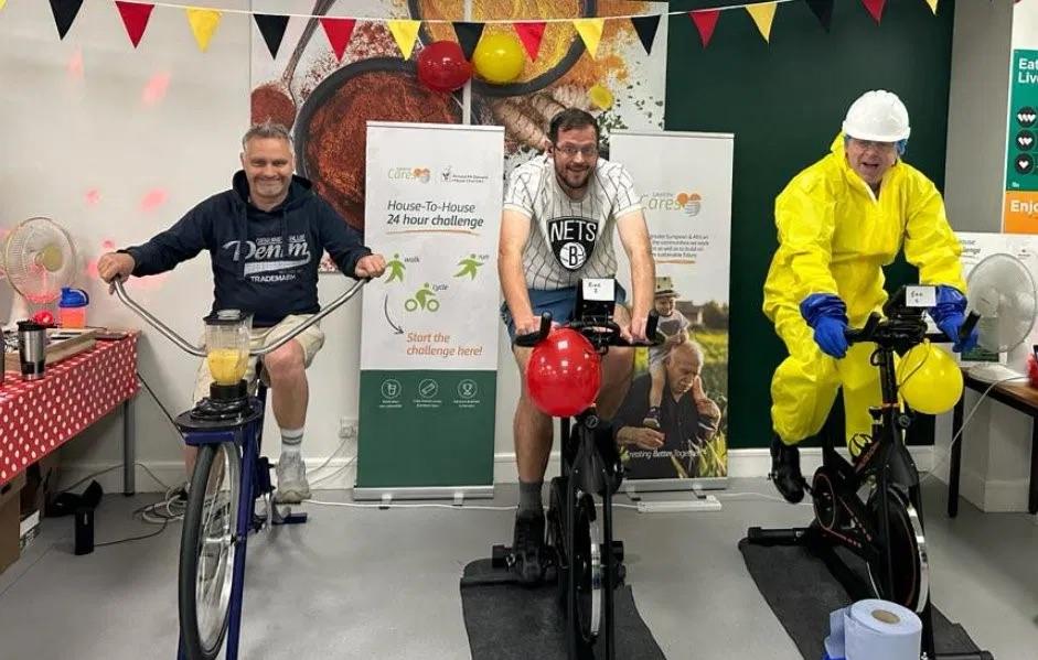 Three people riding bikes to raise donations