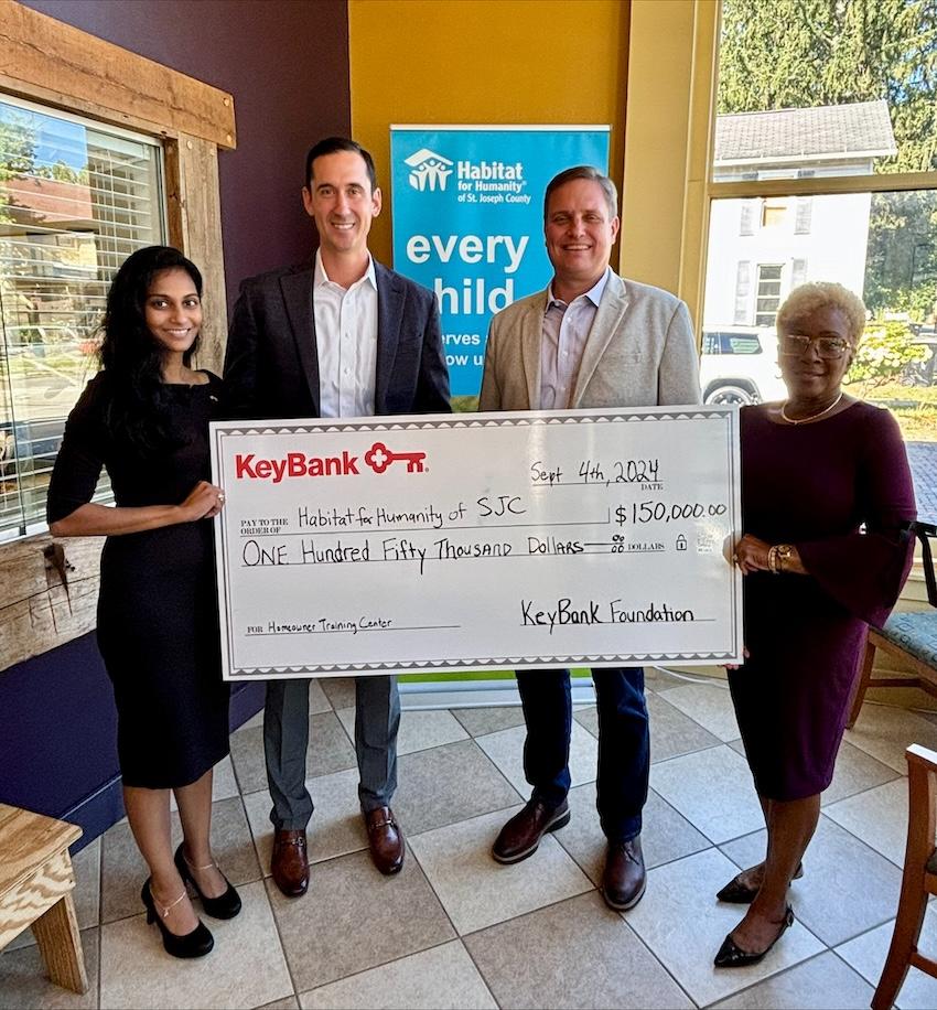 Representatives from KeyBank and Habitat for Humanity shown with a $150,000 grant check.