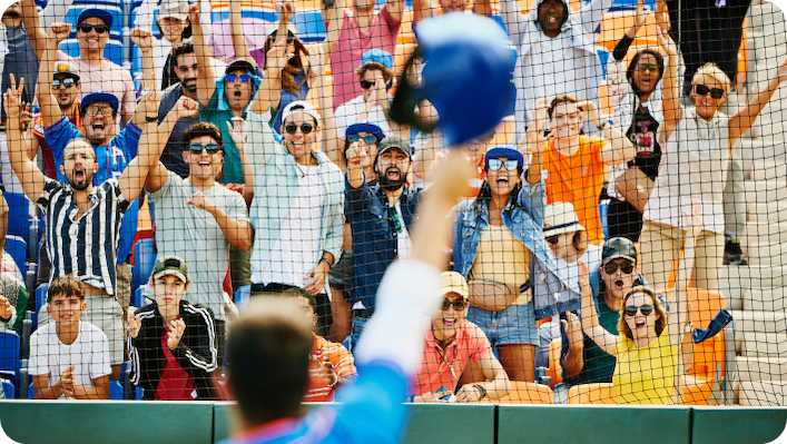 Fans at a baseball game cheering for a player.