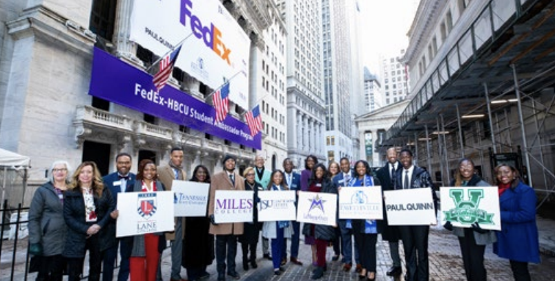 A large group of people holding signs with logos on 