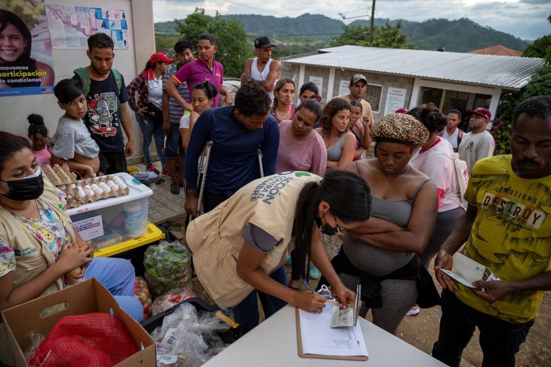 Action Against Hunger workers register migrant families for assistance.