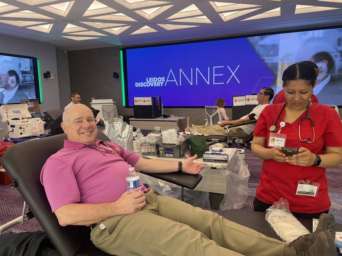 man smiling preparing to donate blood