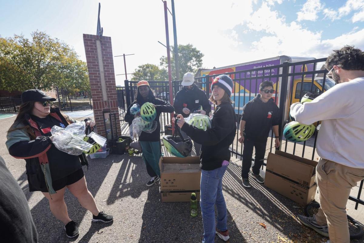 AEG employees helped outfit each student with the correct bike size and helmet. (Photo: Jon Angel)