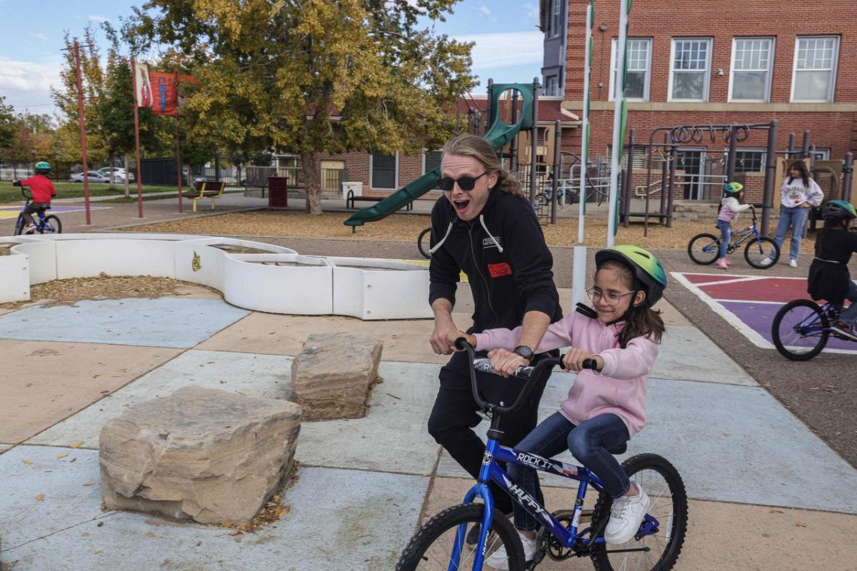 AEG employees helped teach the students how to ride a bike. (Photo: Jon Angel)