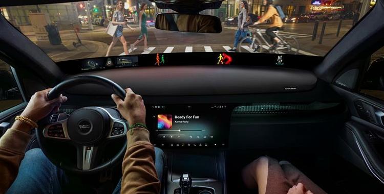 A couple seated in a car with the information system shown.