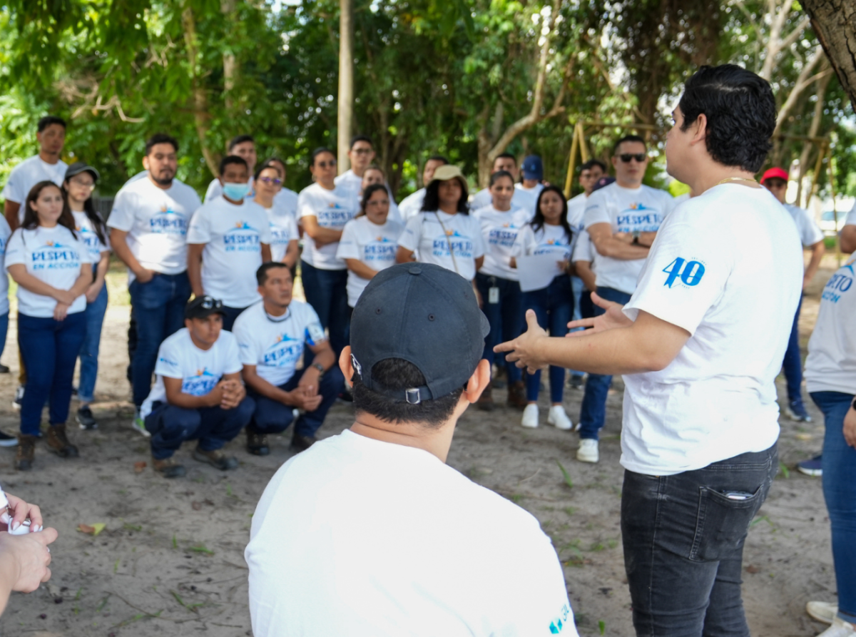 Gildan employees featuring "Respect in Action" and 40th anniversary t-shirts, standing in a circle during a volunteering activity