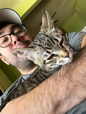 Jacob Rodriguez holding his cat.