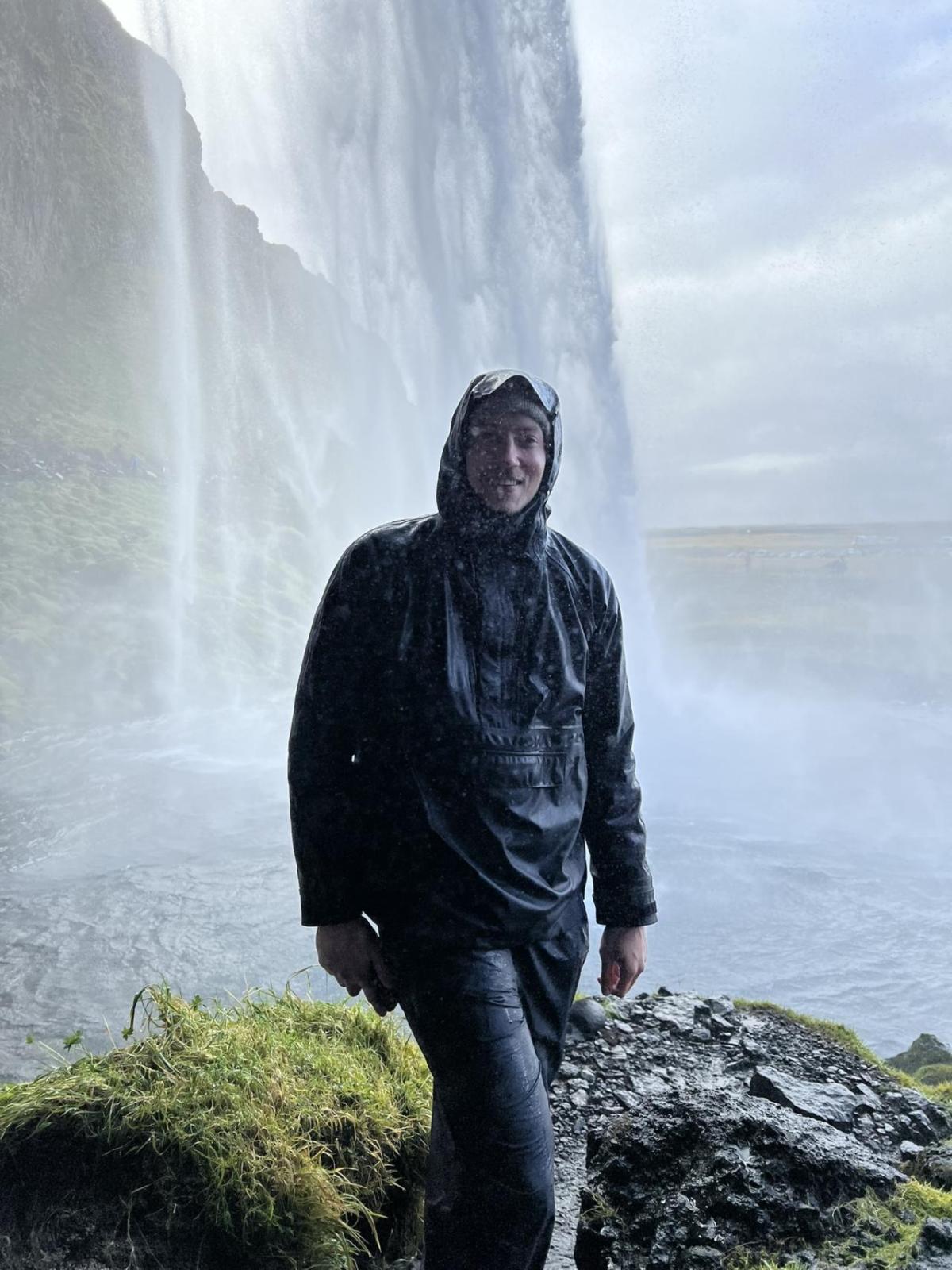 Josh Casemier stood in front of a waterfall 