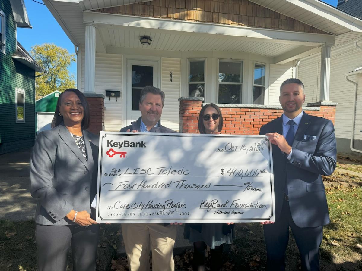 KeyBank and LISC Toledo leadership shown with a $400,000 grant check.