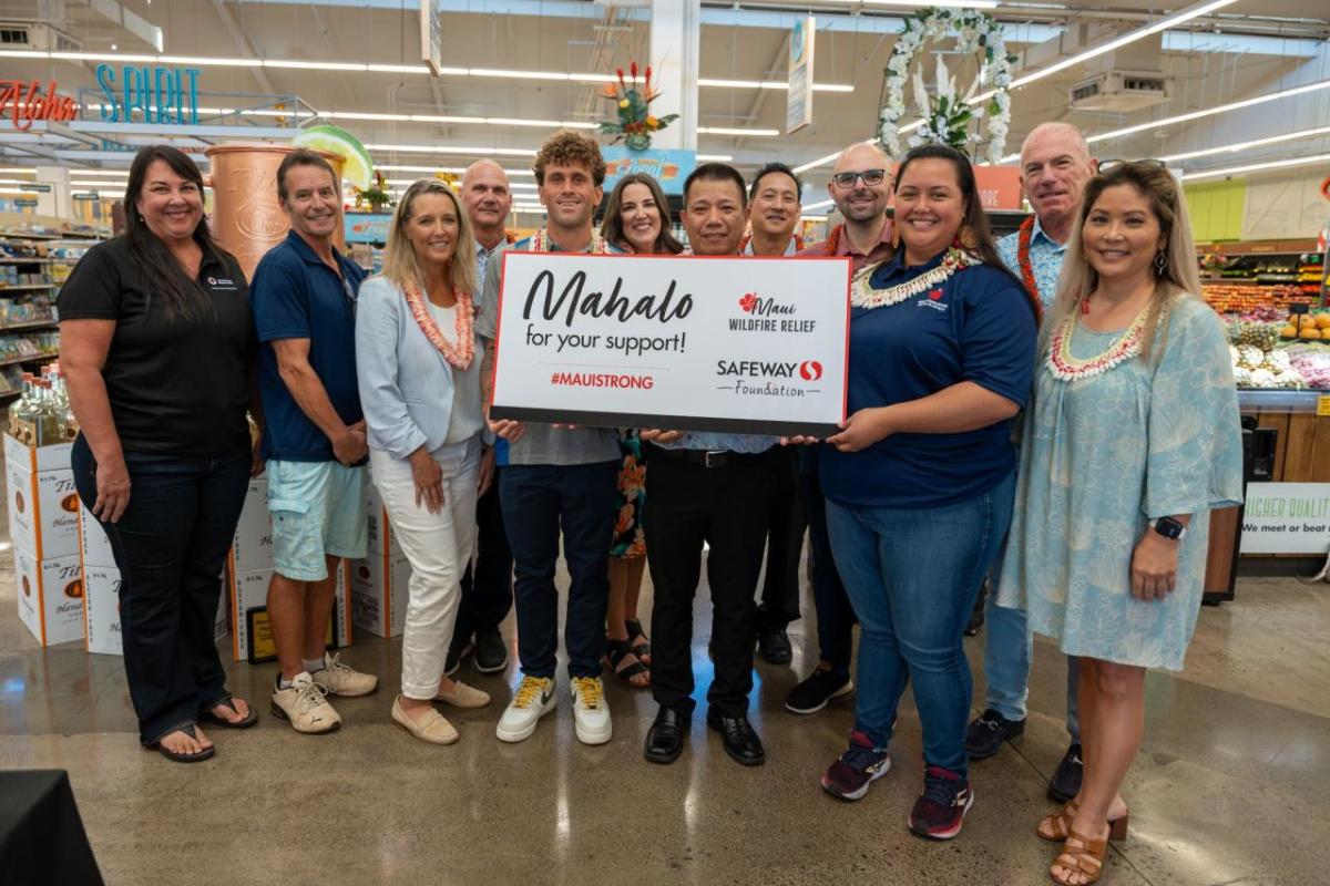 Group of people posing with check