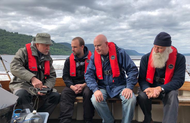 Eric Verspoor, Gert-Jan Jeunen, Neil Gemmell, and Adrian Shine aboard the boat Deepscan on Loch Ness. | Photo by Neil Gemmell