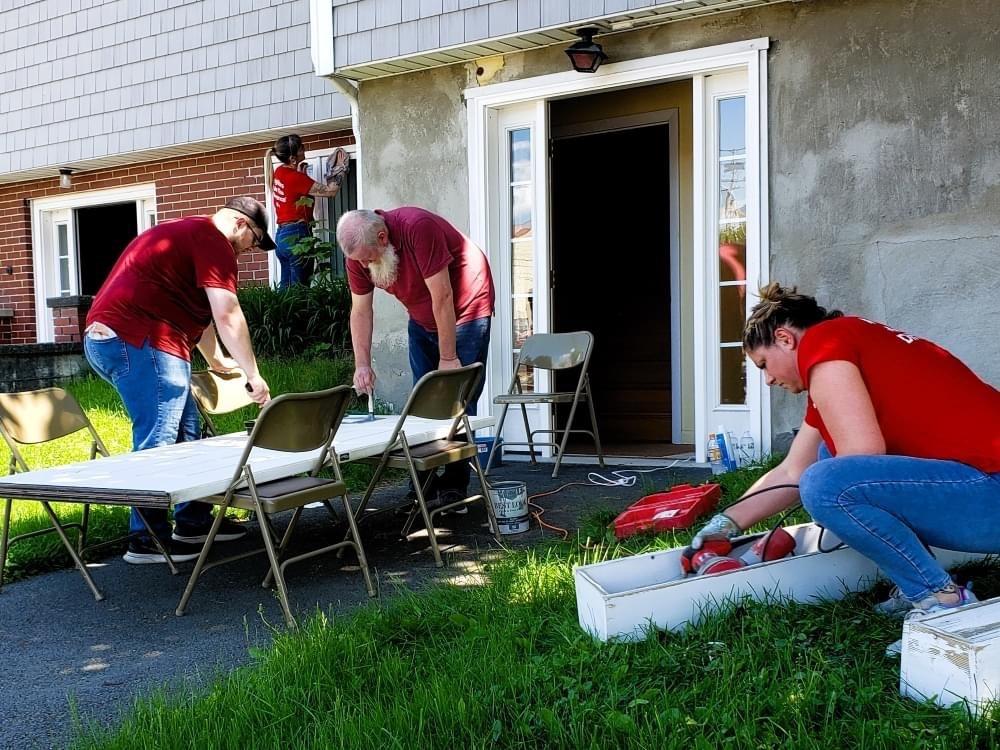 KeyBank volunteers shown working on the exterior of a home.