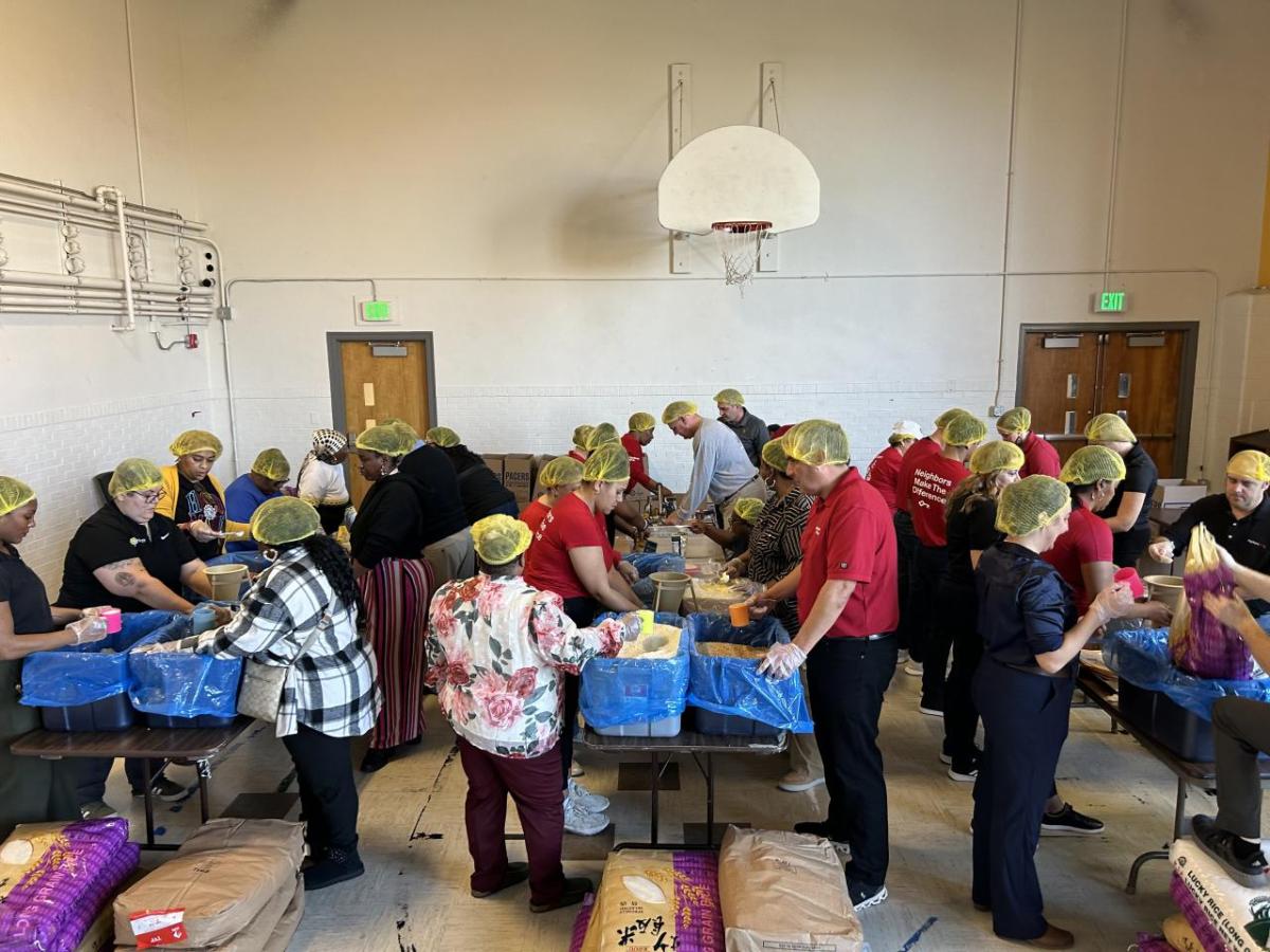 KeyBank and Edna Martin Christian Center volunteers pack meals for those in need.