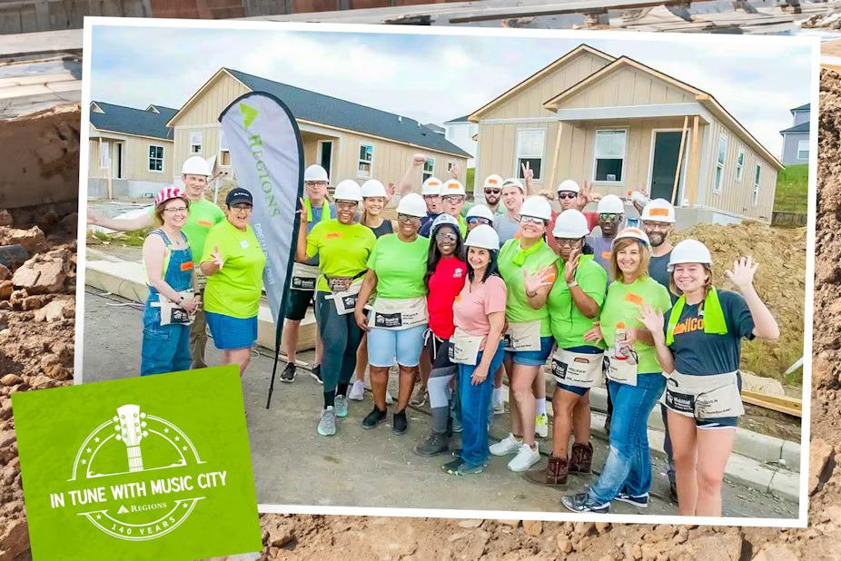 A group of volunteers posed outside a home being built.