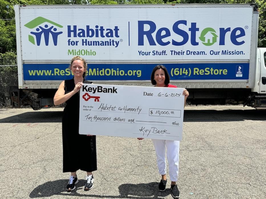 KeyBank volunteer shown with Habitat for Humanity volunteer with a $20,000 grant check.