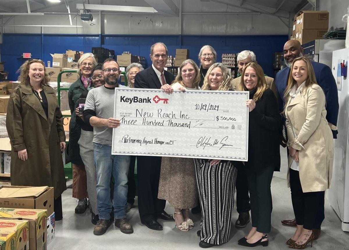 New Reach and KeyBank team shown with grant check.