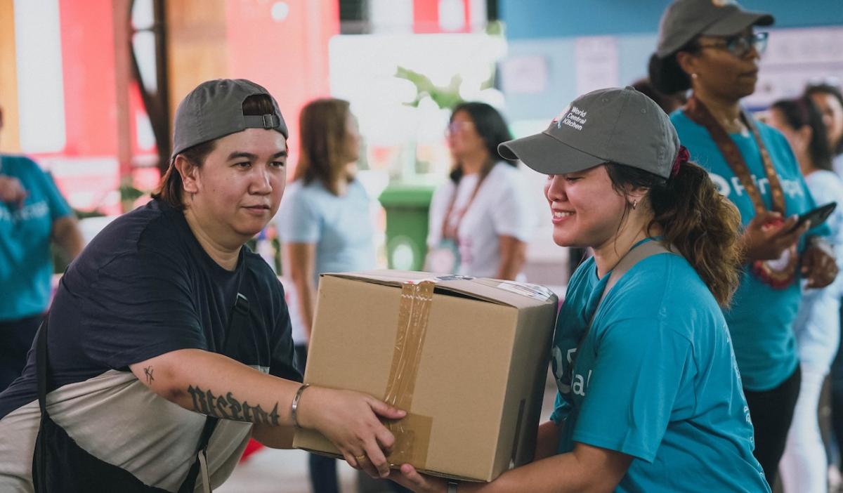 In Manila, Philippines, Principal employees put the finishing touches on packaged meals to be donated locally.