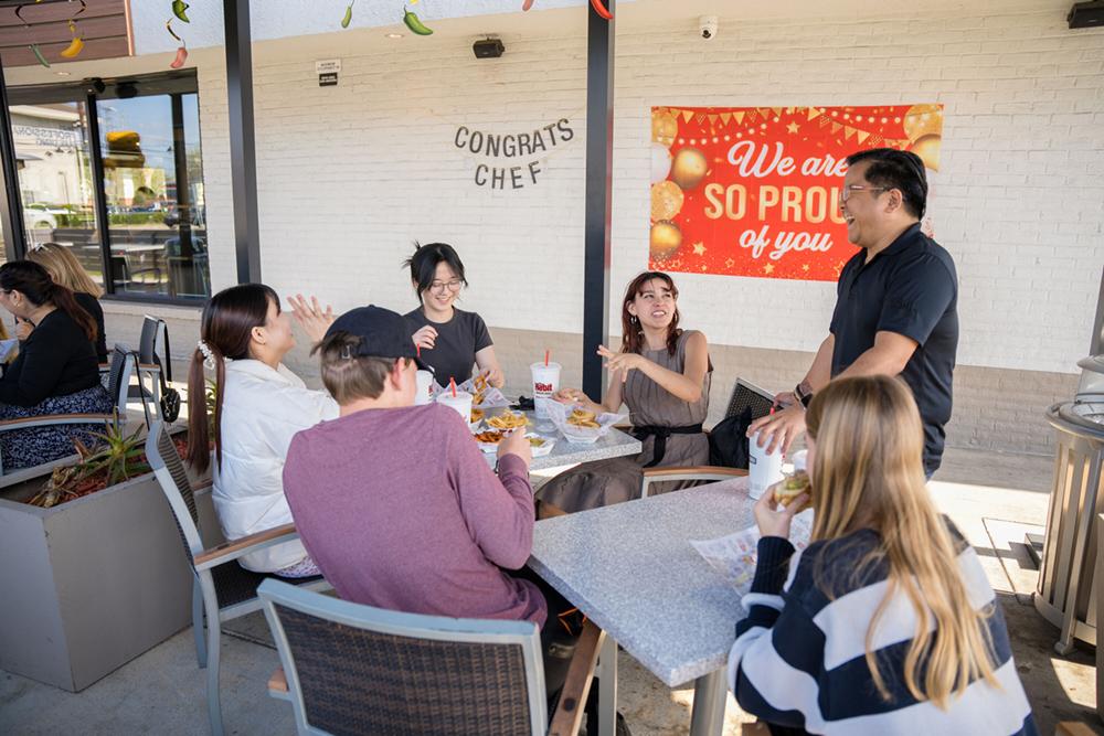 People sat around tables eating food