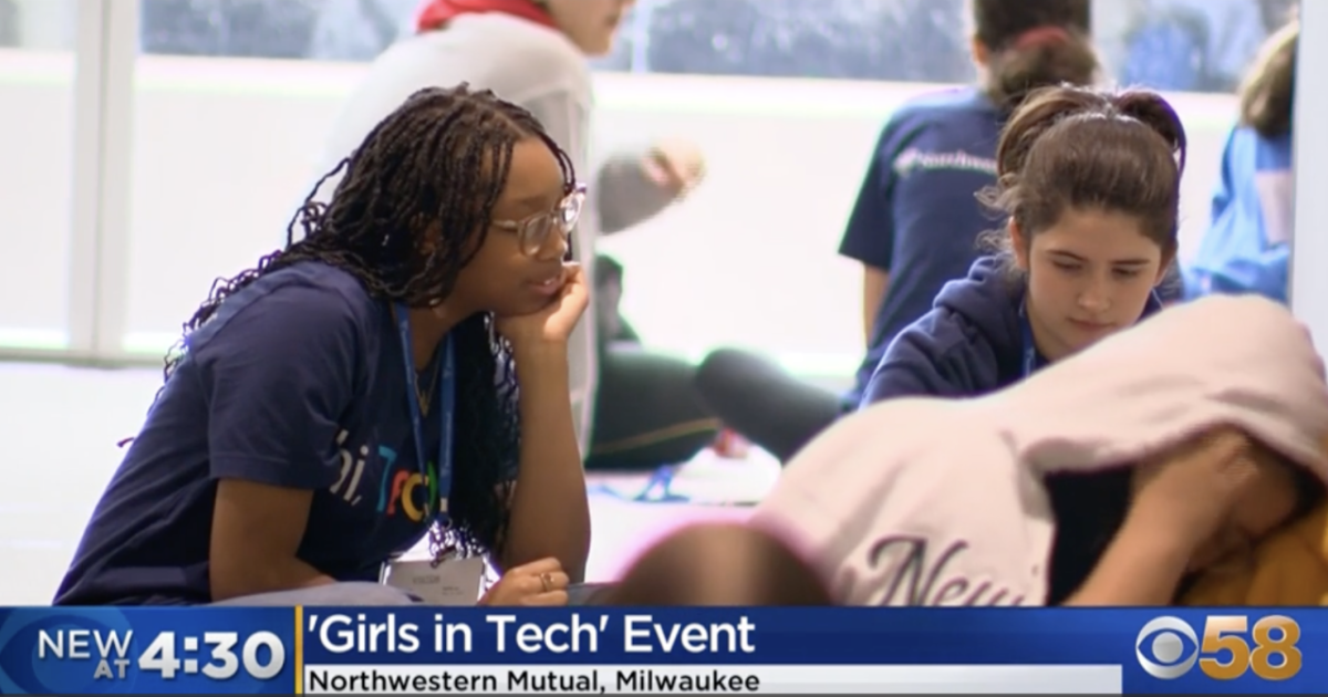Young women in lanyards working together at a group event