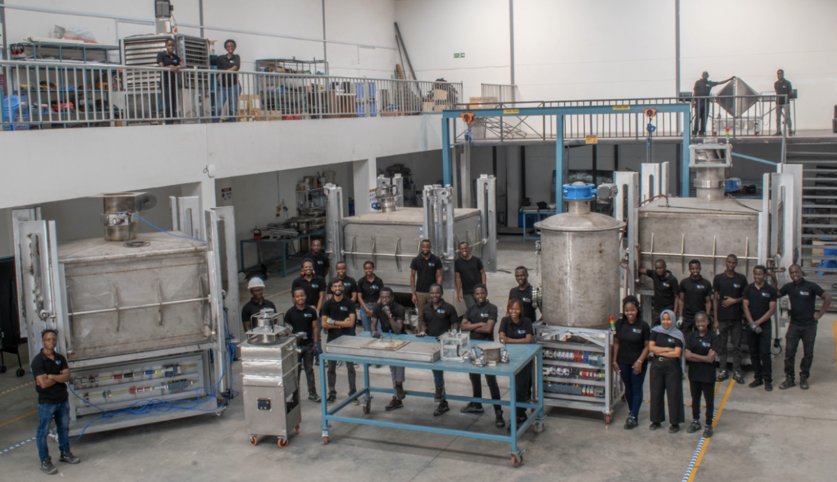 Members of the Octavia Carbon team posing with some of the DAC machines they have helped develop.