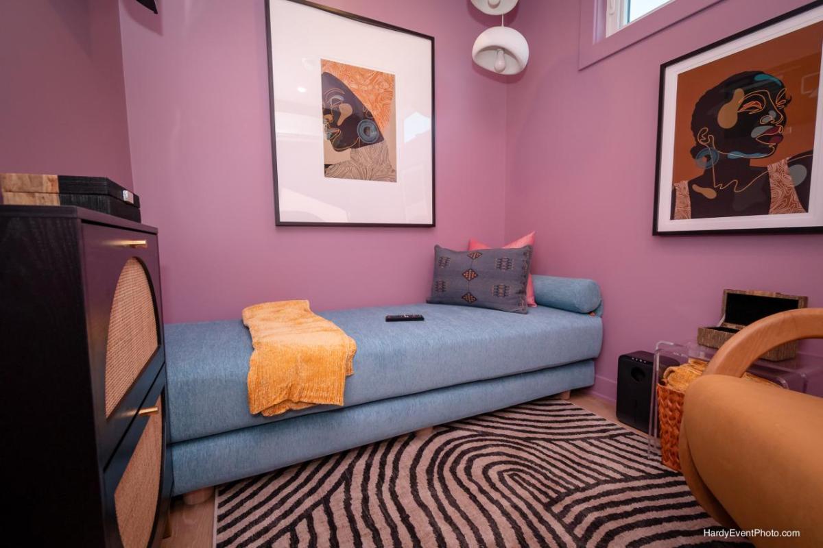 Photo of a SheCare Wellness Pod with a couch, easy chair and art on the walls.